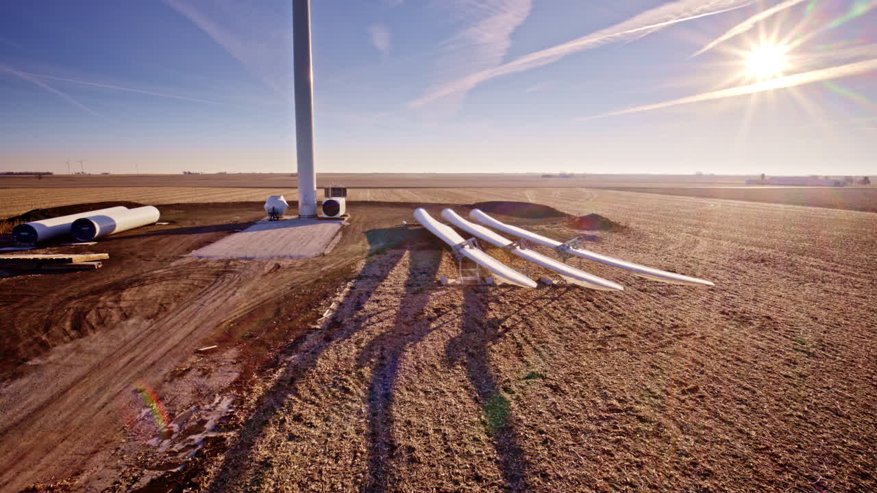 Drone shot slowly flying around windmills being constructed