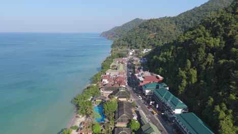 aerial drone footage of white sand beach village, koh chang, thailand. capturing sunny morning views of the coast and tropical scenery
