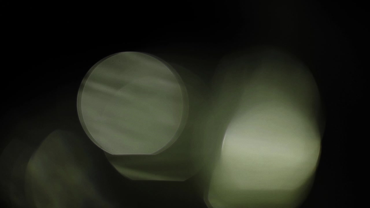 Soft Green Lens Flares and Bokeh on Black Background