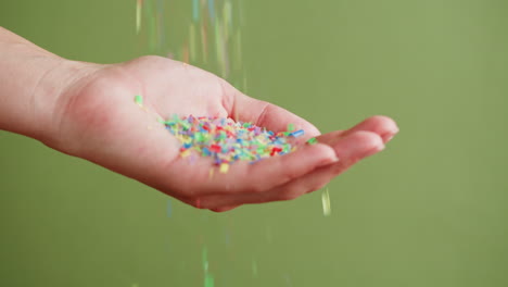 colorful plastic confetti in hand