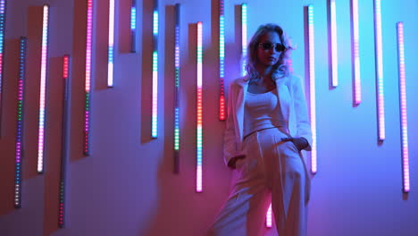 stylish woman in white outfit under neon lights