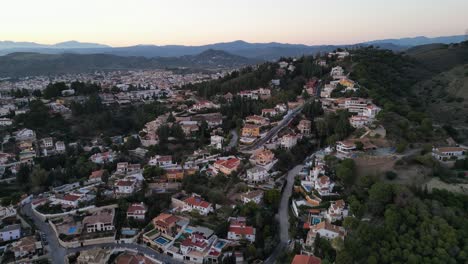 Malaga-luxury-neighborhood-villas-with-swimming-pools-during-twilight-in-Andalusia,-Spain---Aerial