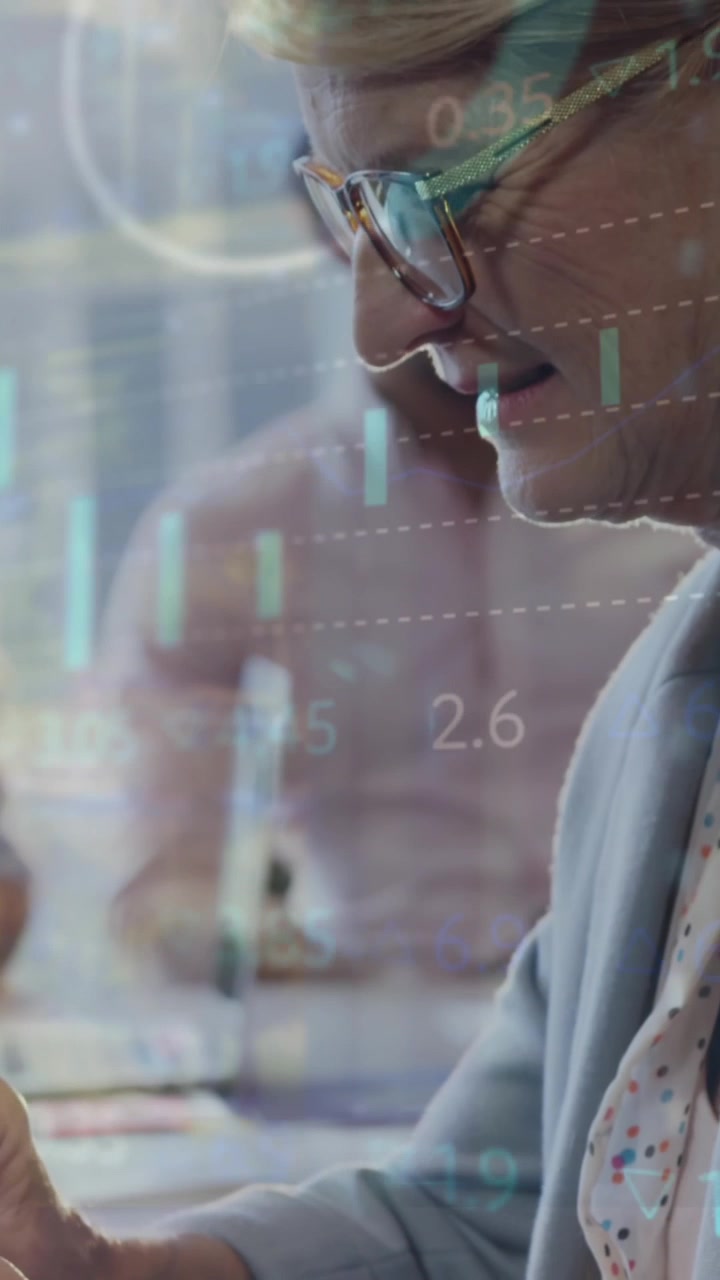 Animation of statistical data processing over caucasian senior businesswoman using tablet at office