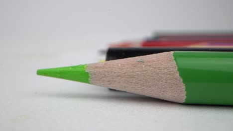 sharp green pencil on white surface