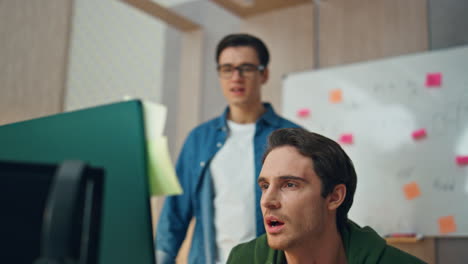 two men working office blur effect. closeup inspired colleagues staring monitor