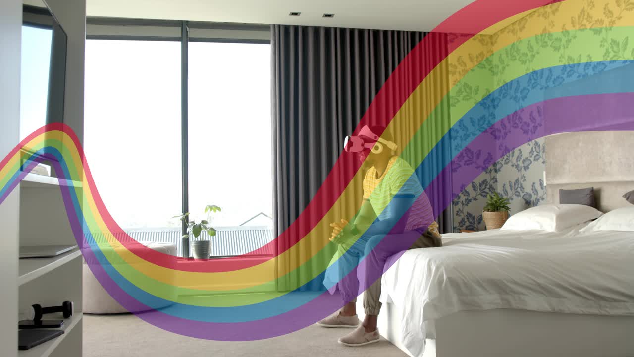Man with VR headset adjusting, reaching bedside while rainbow arcing over him starting tech demo