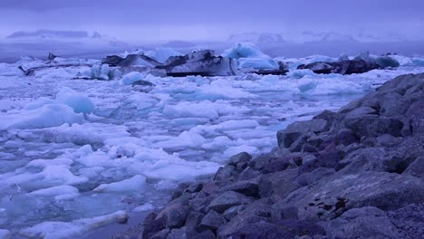 pan across icebergs sitting in a glacial bay suggesting global warming in the arctic at jokulsarlon glacier lagoon iceland night