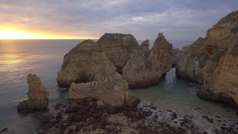 sunrise over dramatic coastal cliffs and rock formations