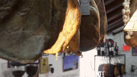 slowmotion shot of dry-aged meat hanging from the ceiling to cure