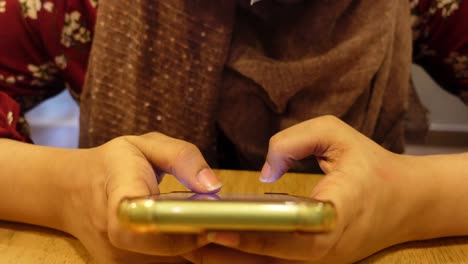 woman using a mobile phone in a cafe