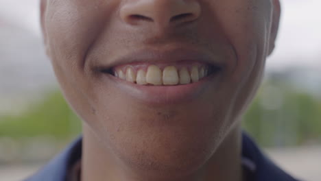 closeup shot of young african american man smiling outdoor.