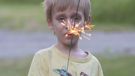 cute little boy holding a sparkler