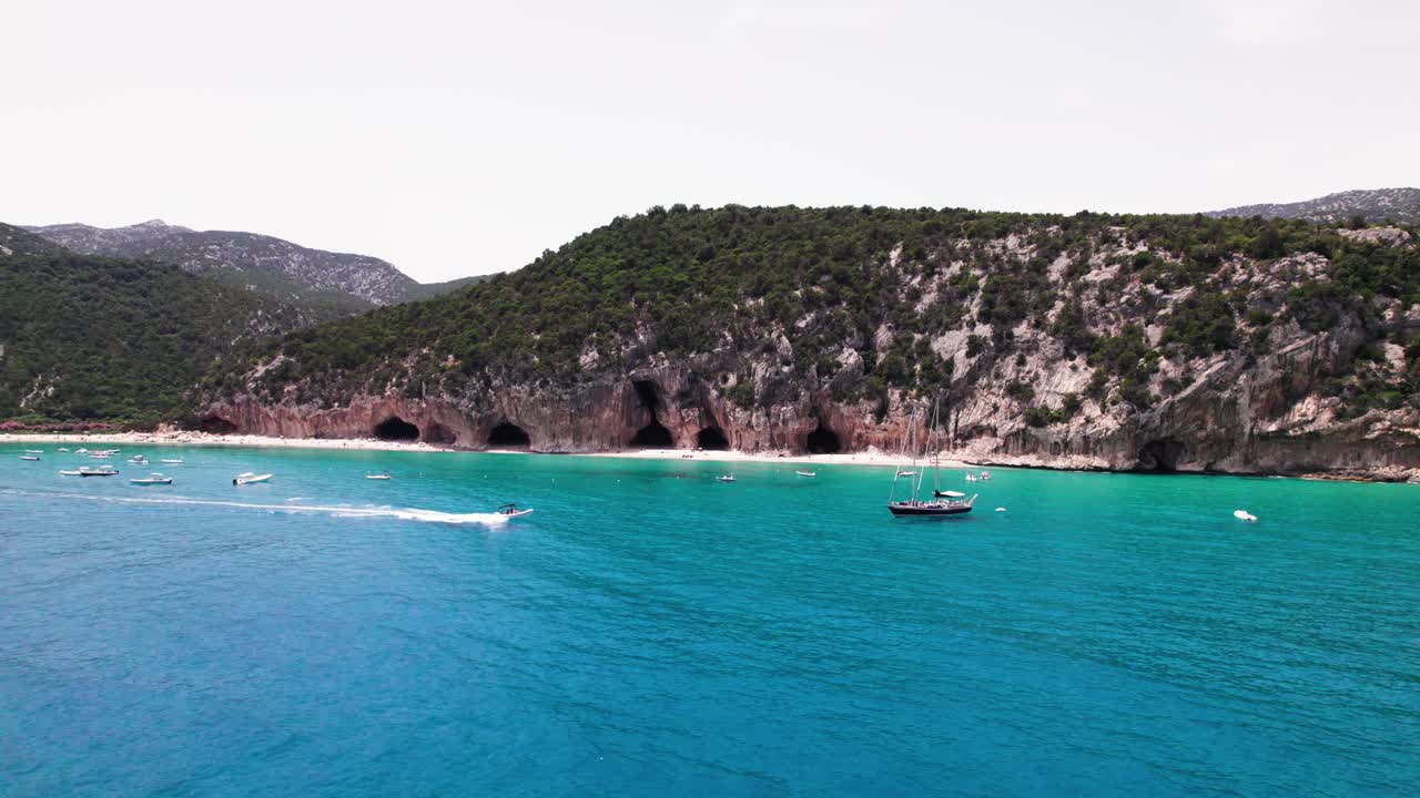 Aerial seascape of speed boat cruise on turquoise mediterranean sea, Sardinia coast