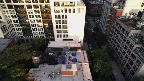 aerial view in front of a apartment revealing downtown of brooklyn, golden hour in ny, usa - tracking, tilt, drone shot