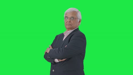 Portrait-of-Indian-senior-businessman-standing-crossed-hands-Green-screen