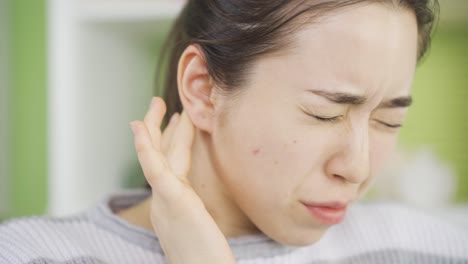 young woman with otitis media feels severe and prolonged pain.