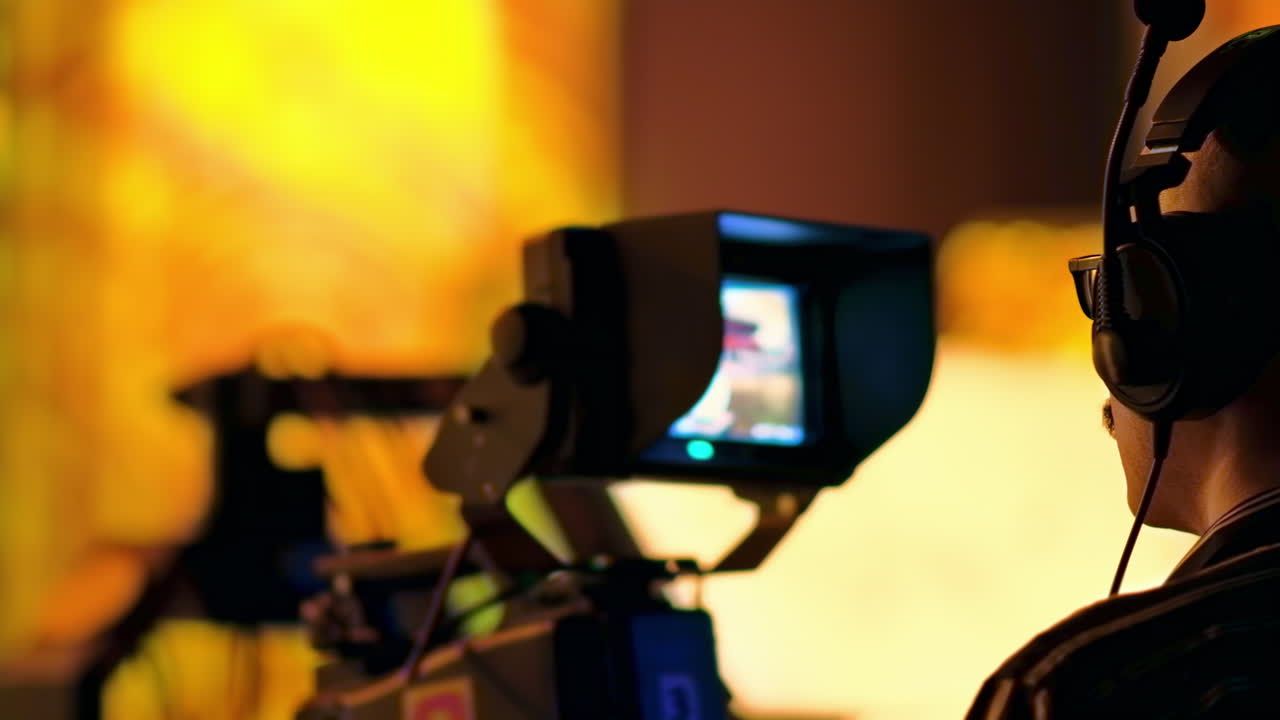 Man filming with professional camera on the backstage of a TV set