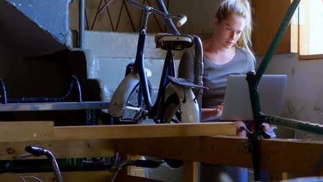 woman using laptop at workshop 4k