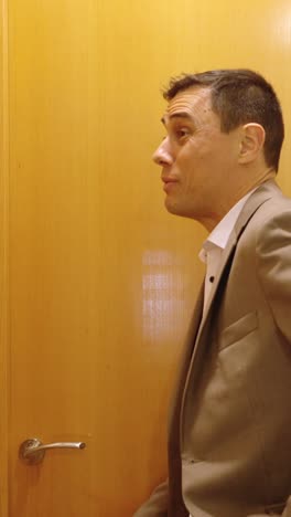impatient businessman waiting for wife in bathroom