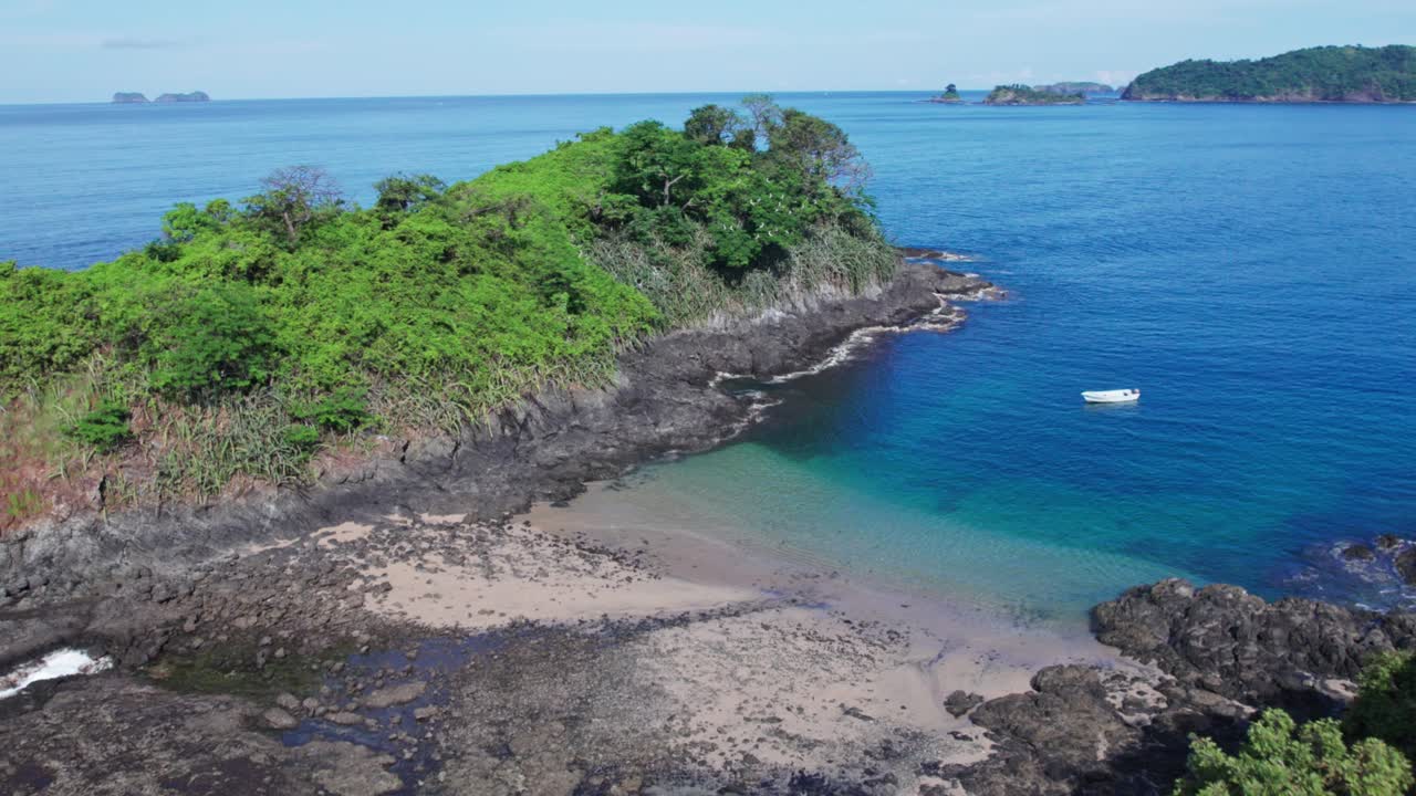 pequeño bote anclado en medio de dos pequeñas islas