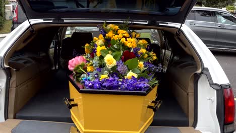 closeup shot of a funeral casket in a hearse or chapel or burial at cemetery