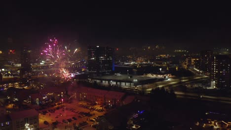 dazzling fireworks exploding on new year's eve in iceland. orbiting drone shot