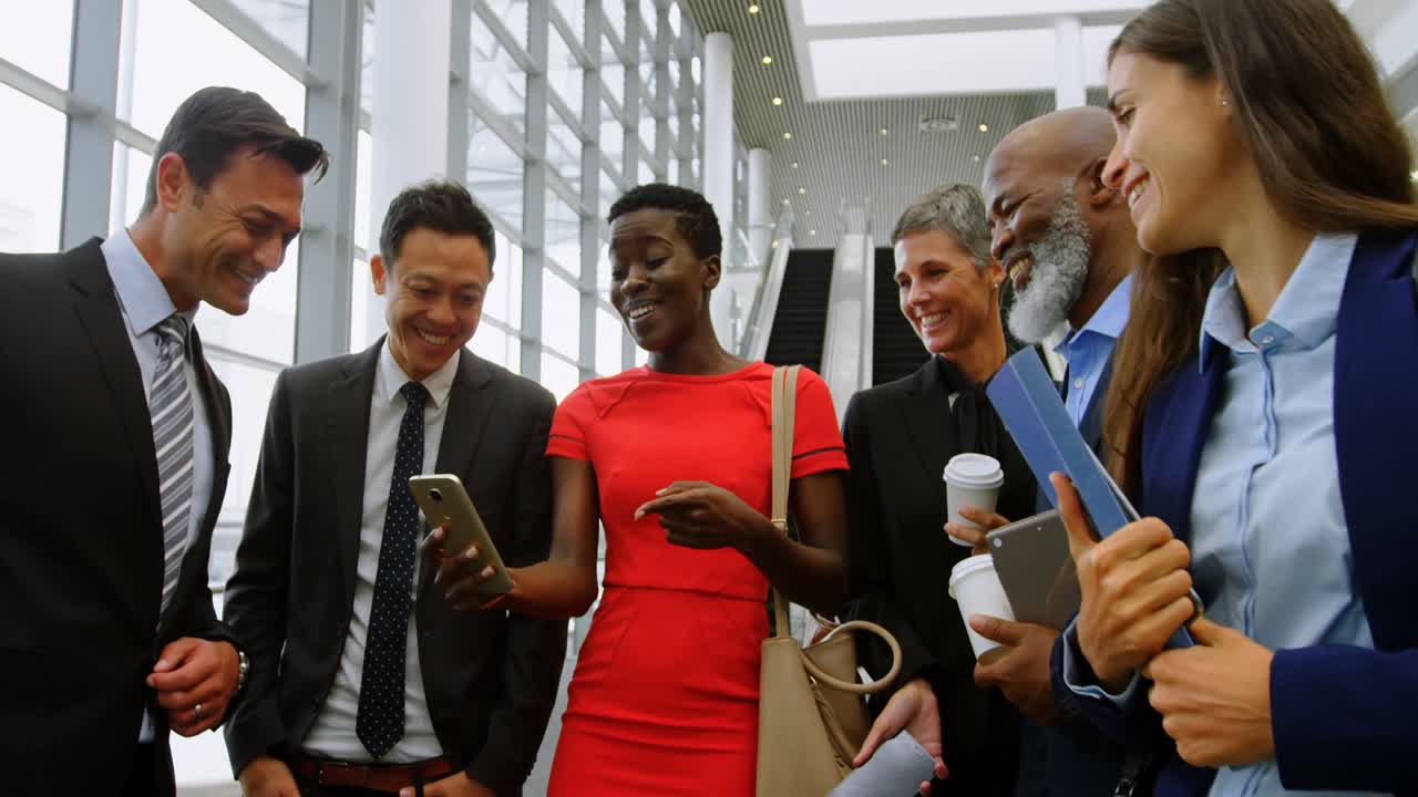 Group of happy business people looking at the mobile phone 4k