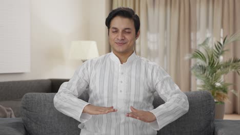 Happy-Indian-man-doing-breathe-in-breathe-out-exercise