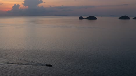 Wide-shot-of-a-ocean-area-near-bay-with-single-boat-returning-to-harbor