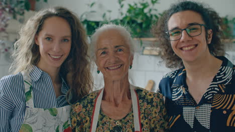 portrait of cheerful elderly woman with grandchildren in kitchen
