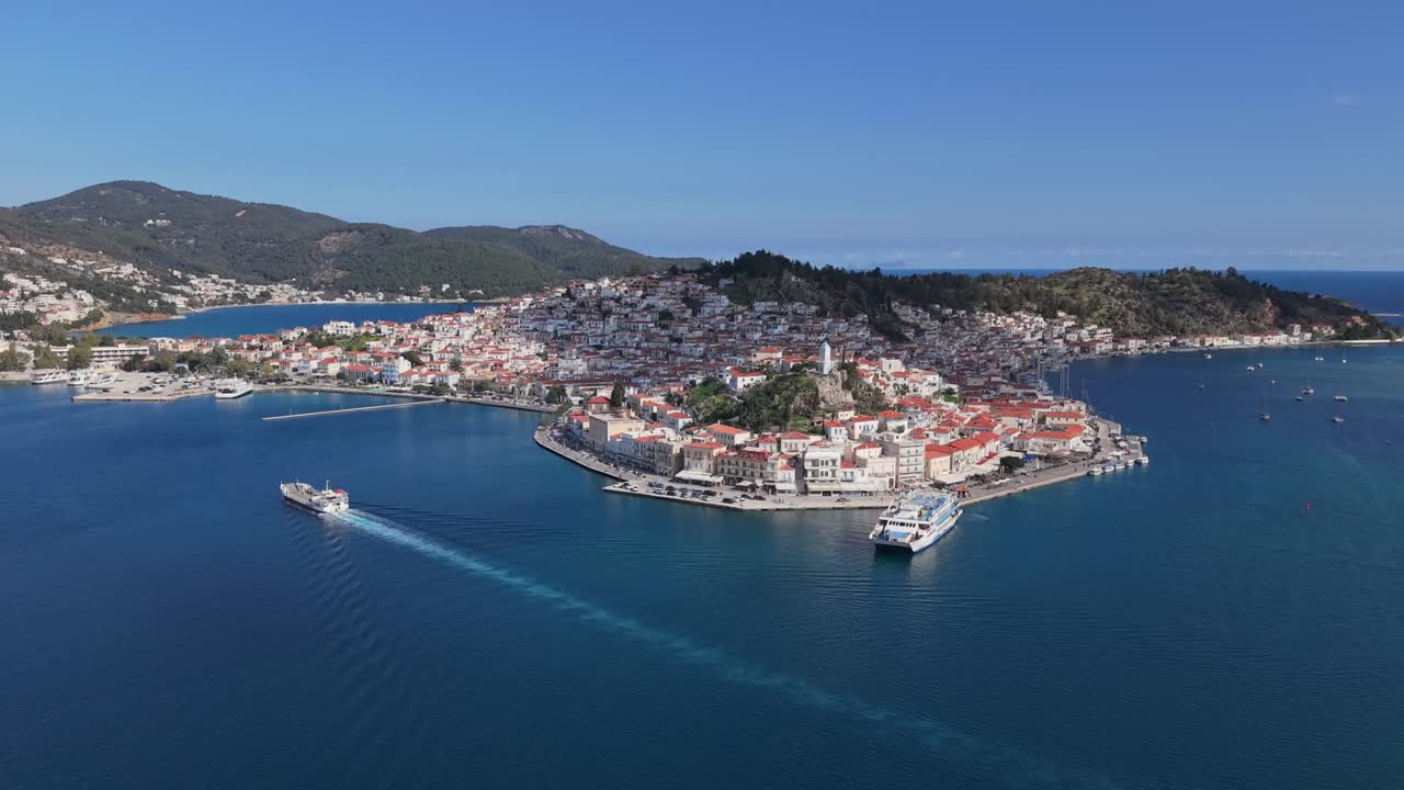 Panoramic view of Poros Island with blue sea, clear sky, and traditional landscape, showcasing the beauty and charm of this Greek island destination