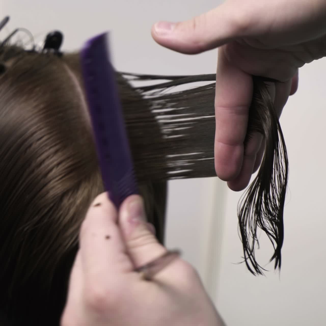 Hairdresser cutting hair of her customer