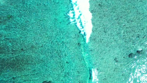 abstract water texture, tropical sea , maldivian island flying over shallow water and coral reef