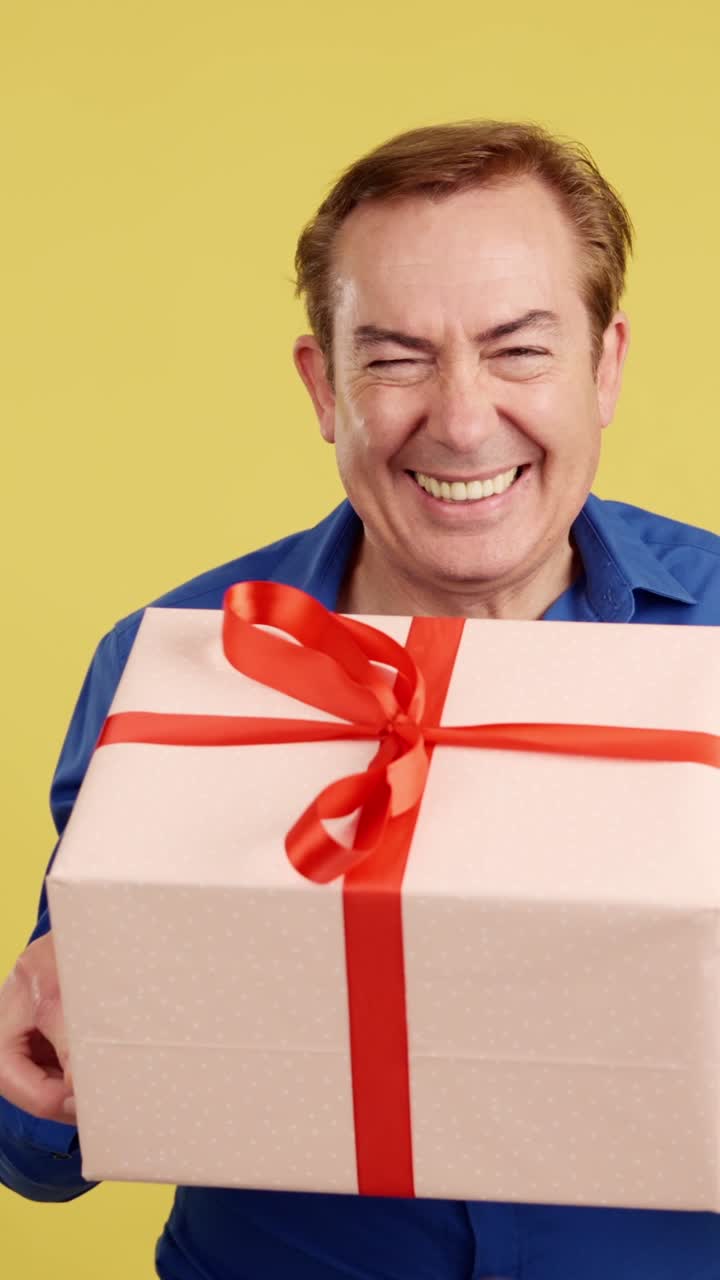 Happy Man Holding a Gift and Winking
