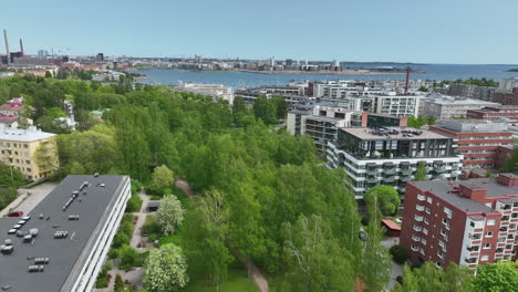 Aerial-view-of-fresh-spring-greenery-in-Helsinki,-sunny-day-in-Uusimaa,-Finland