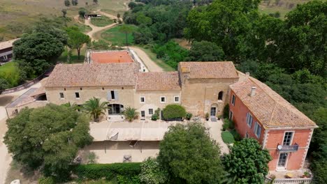 aerial establishing shot of a large villa with tennis court in st colombe