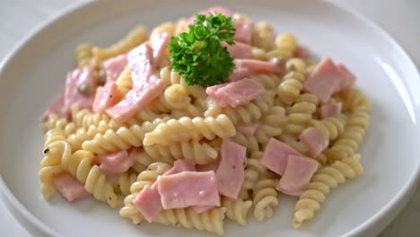 spirali or spiral pasta mushroom cream sauce with ham - italian food style