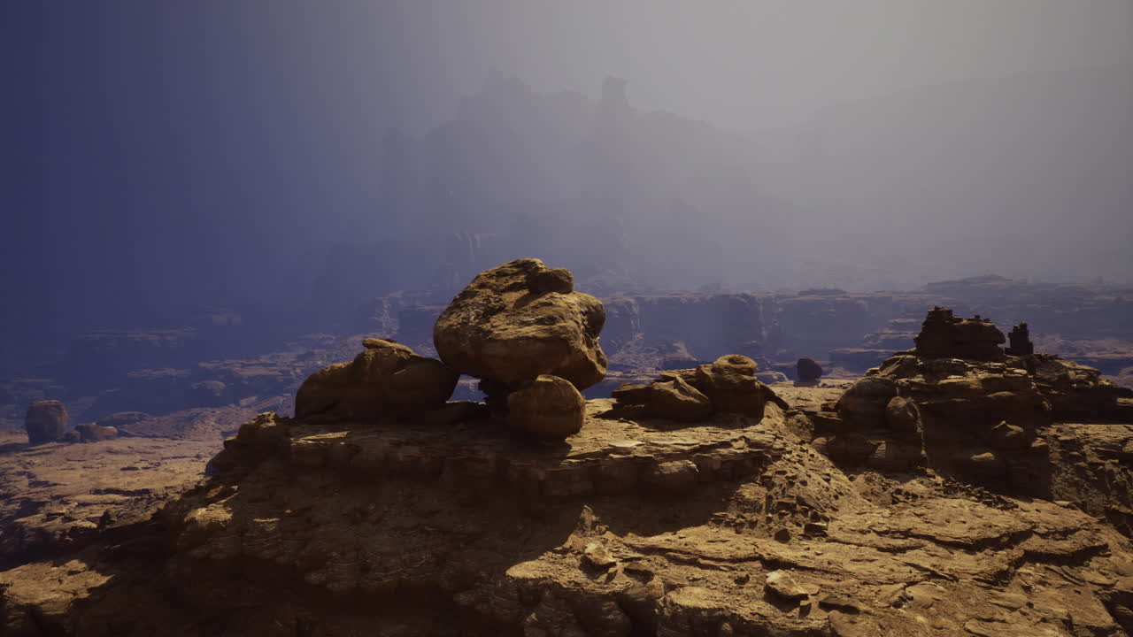 Natural rock formations under a foggy sky in a desert landscape