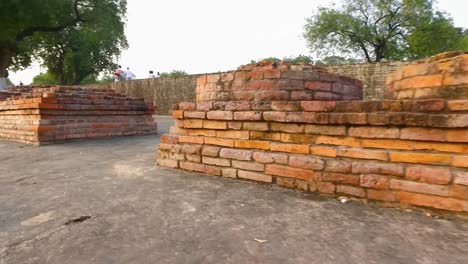 the ancient ruins of the archaeological site in sanarth, varanasi, india with close up of brick pedestals