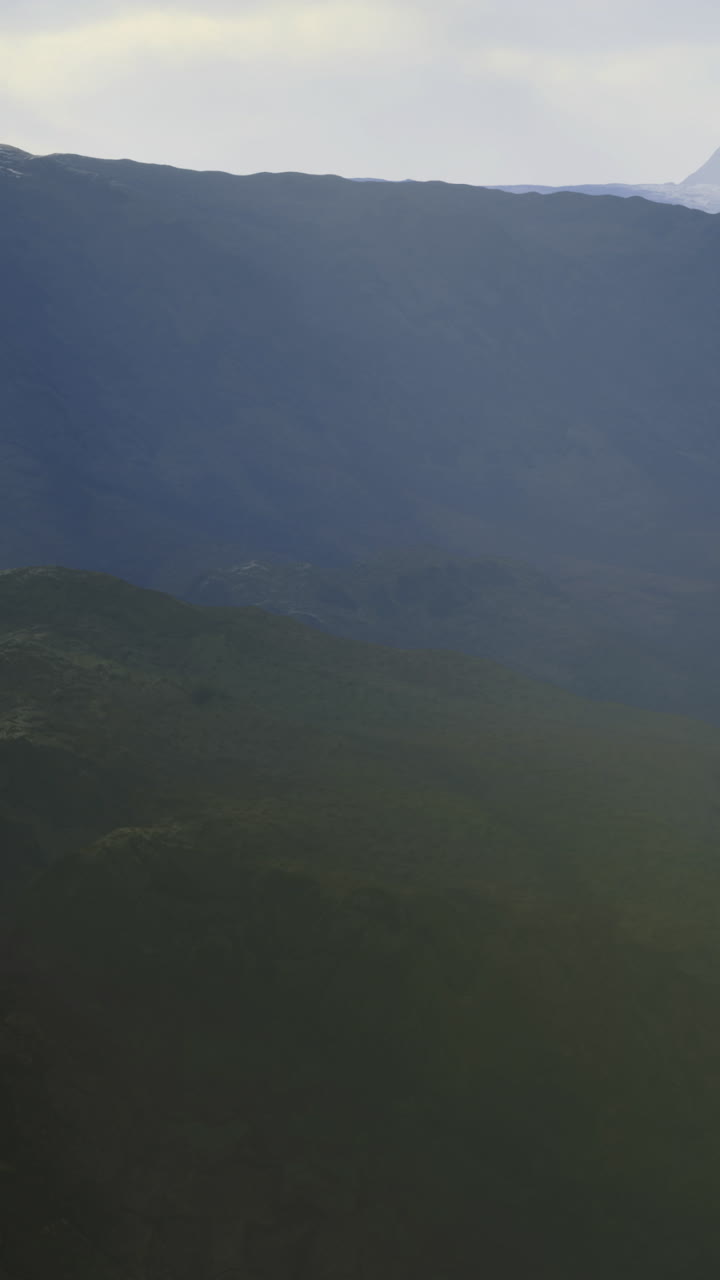 Breathtaking view of misty mountains at dawn reveals natures serene beauty