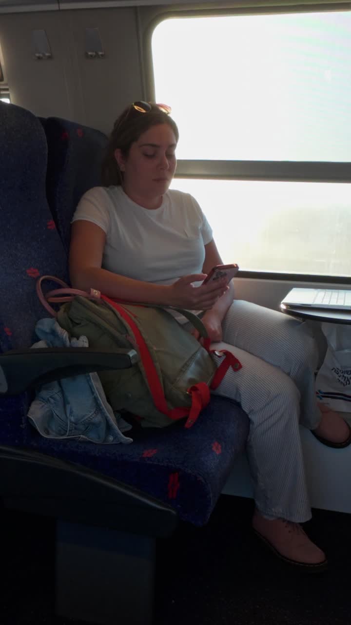 Female Traveler Occupying Two Seats on a Train Commute