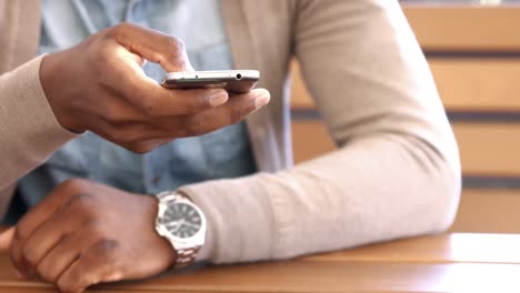 mans hand using smartphone