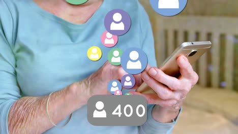 animation of media icons over senior caucasian woman using smartphone