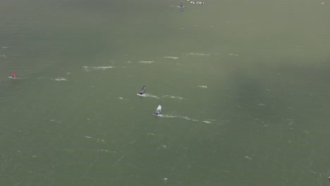 Top-down-view-of-windsurfing-at-Ijsselmeer-near-Makkum,-aerial