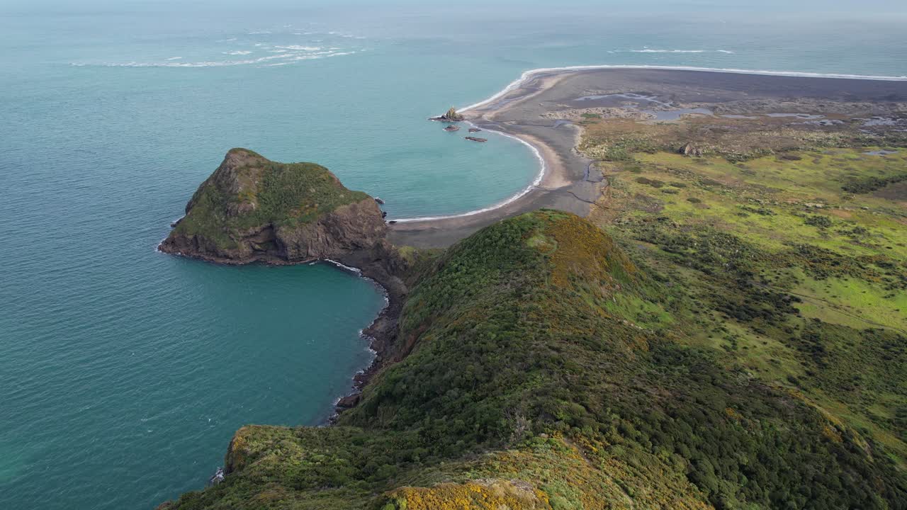 Aerial view of a scenic coastline with cliffs and greenery