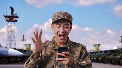 excited military personnel using smartphone