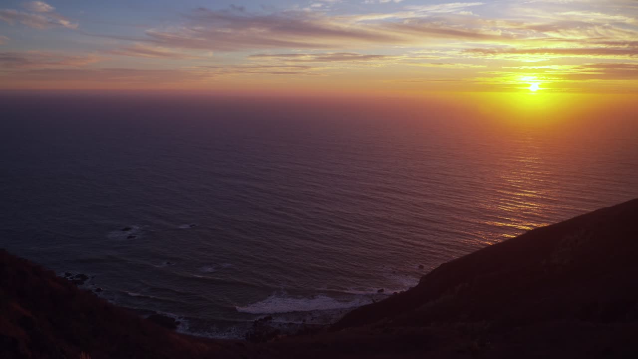 California dreaming sunset sun on horizon North Cali San Francisco Point Reyes Bodega Bay Sonoma Coast State Park Pacific Ocean dreamy orange yellow clouds rugged untouched coastline Big Sur right pan
