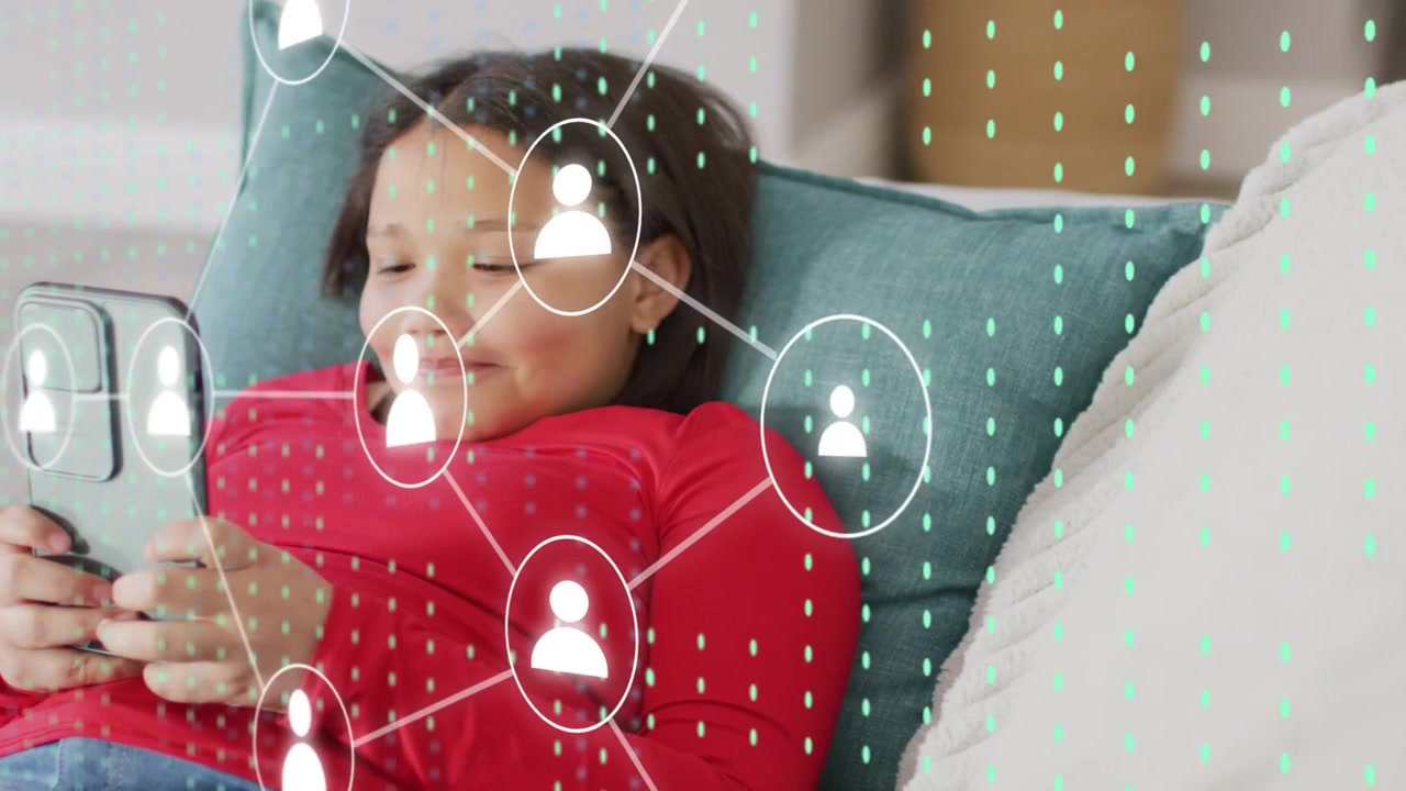 Vertical video: Smiling girl red top using phone on couch, teal cushion and pillow, icons appearin