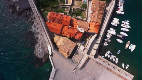 aerial top down view out of harbour and old town city walls of dubrovnik, croatia with mountains and sea in 4k