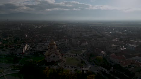 Orthodox-church-in-sunset---cathedral-Catedrala-Sfântul-Ioan-Botezătorul-of-Făgăraș-in-România---bird-view-of-Fagaras-in-Romania-in-winter-with-roundabout---aerial-drone-shot